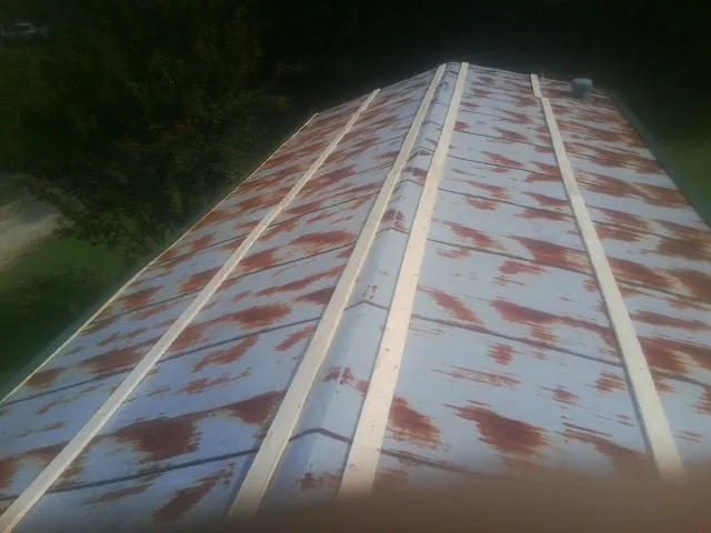 Rusted metal roof panels with new wood purlins before replacement — Storm Damage Roof Repair in Irrigon by Roofing Brothers