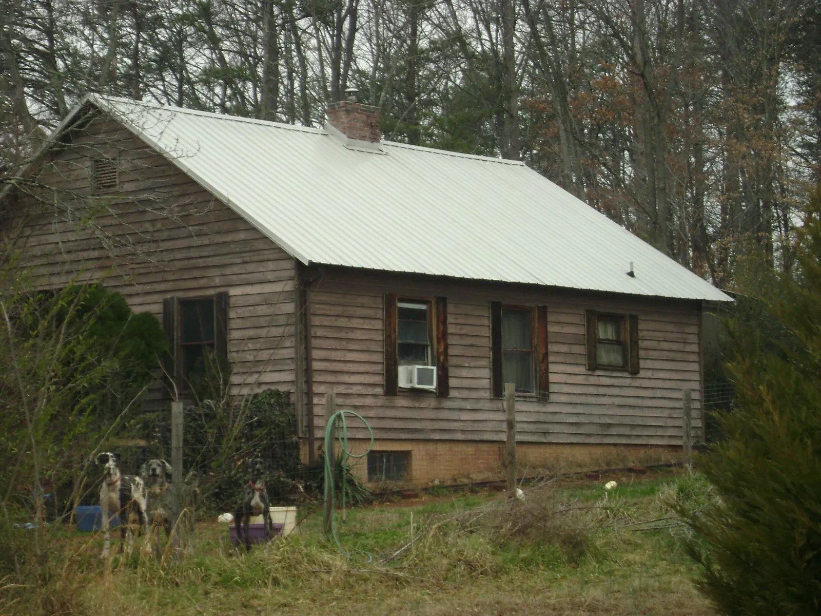 White metal roof on an old wood sided farmhouse, from a Metal Roof Installation job in Irrigon